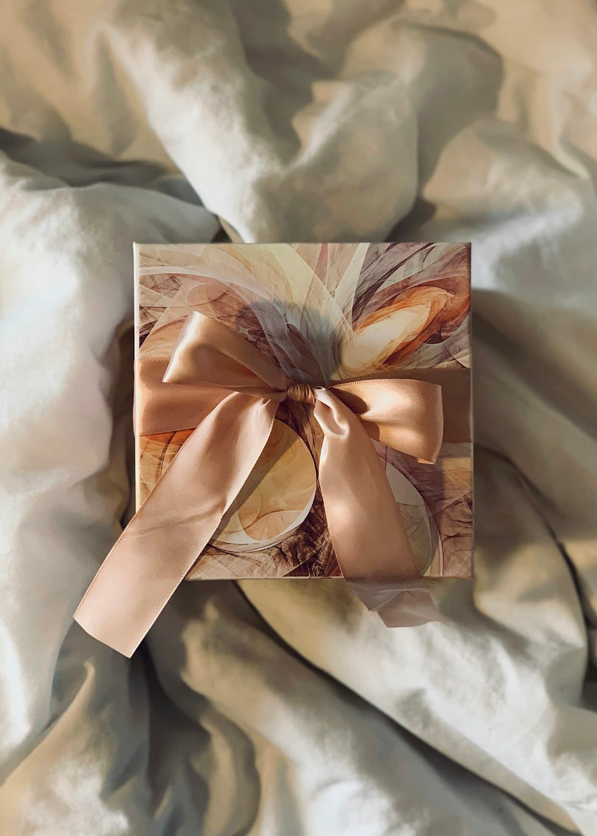 A thoughtfully wrapped bespoke gift box with a satin ribbon